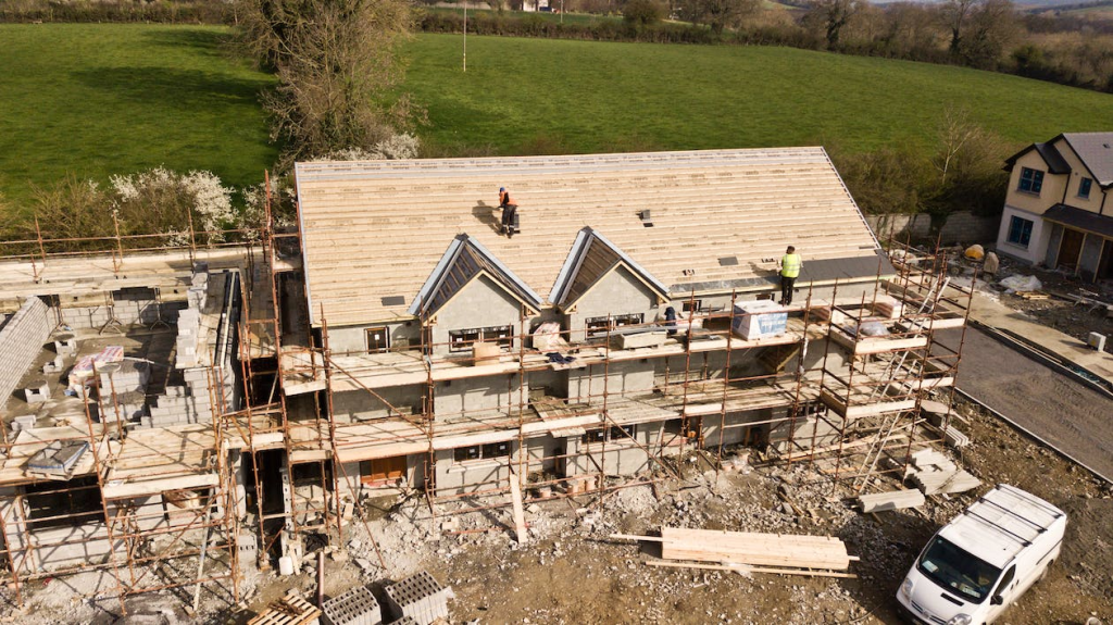 installing a roof on a home under construction