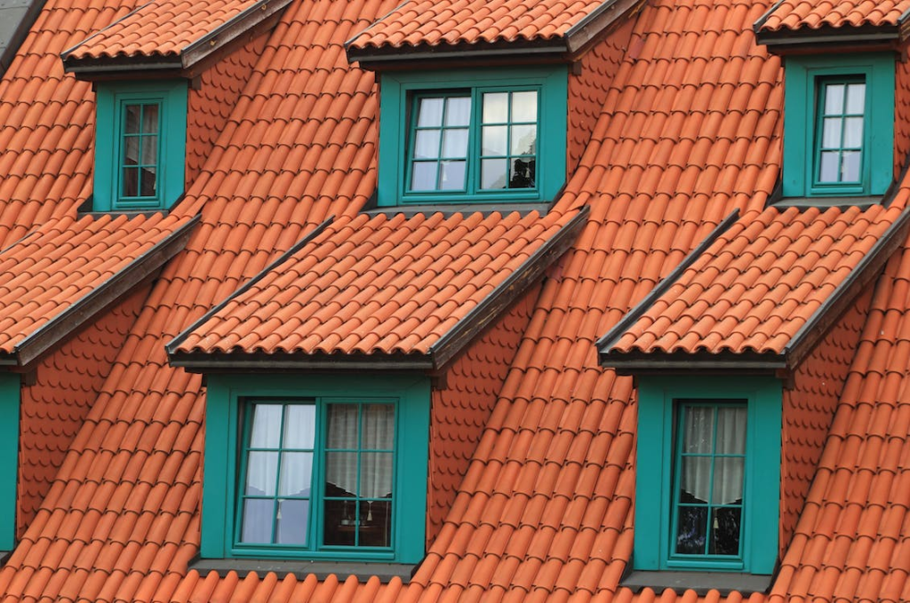 orange shingles on a green house