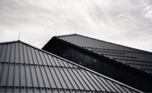 Black metal roofs of two buildings.