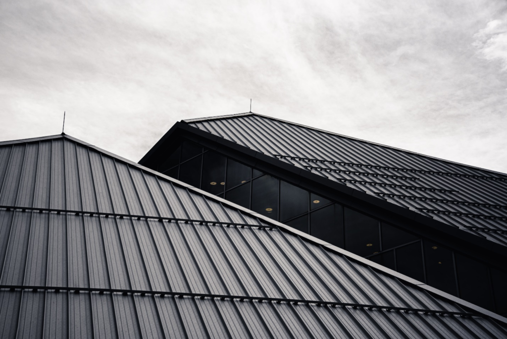 Black metal roof on two houses.