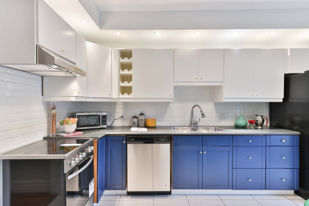 Renovated kitchen with blue and white cabinets.