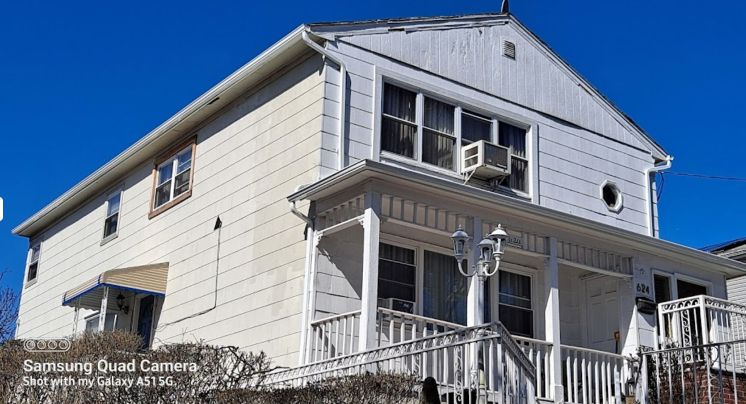 A white house with a newly installed roof