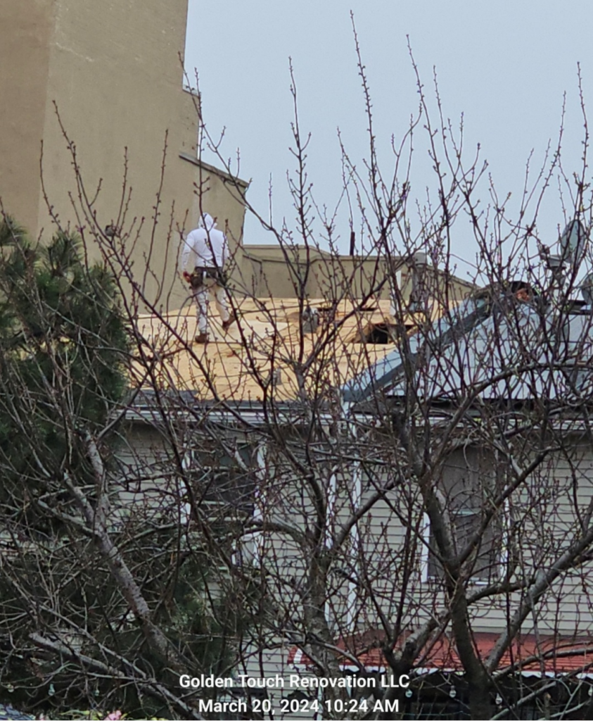 A man walking on a roof currently being installed.