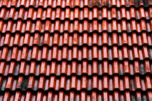 A roof with red metal shingles 