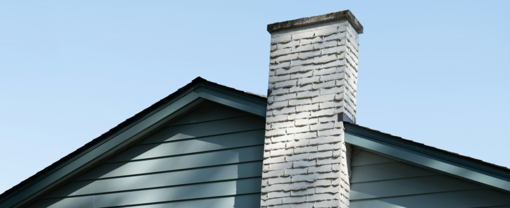 Modern chimney siding styles for 2024 by https://unsplash.com/photos/gray-brick-wall-under-blue-sky-during-daytime--nSvzjjC7J0