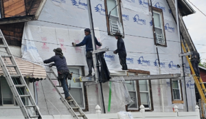 Construction workers renovating the commercial exterior