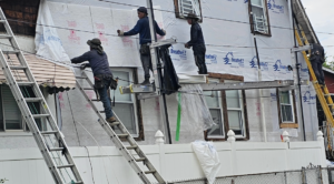 Construction workers renovating commercial exterior