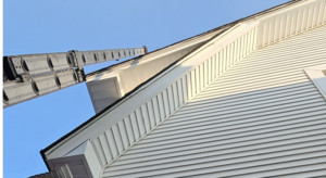 Low-angle view of a white vinyl-sided house