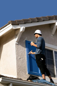 A painter using a roller to apply fresh paint to a wall