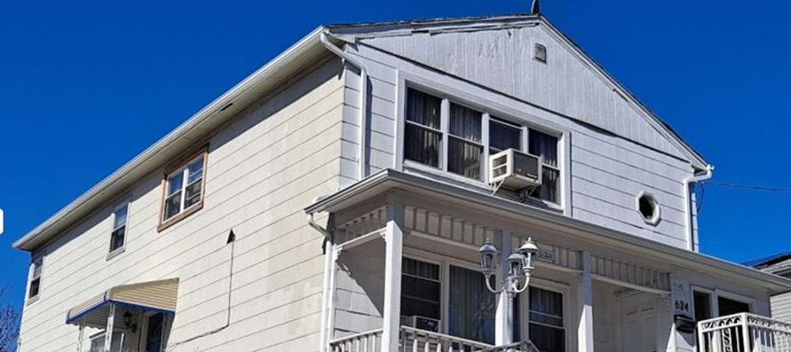 A residential property with white siding.