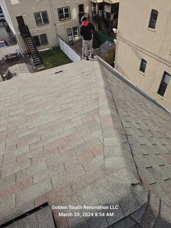 A roof with newly installed asphalt shingles.