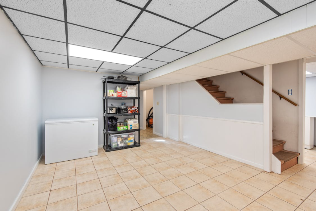 modern ceiling light fixture illuminating a basement room