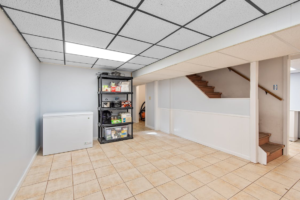 modern ceiling light fixture illuminating a basement room