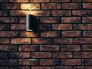 A brick wall with a lamp