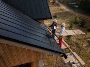 A photo showing two workers installing a roof