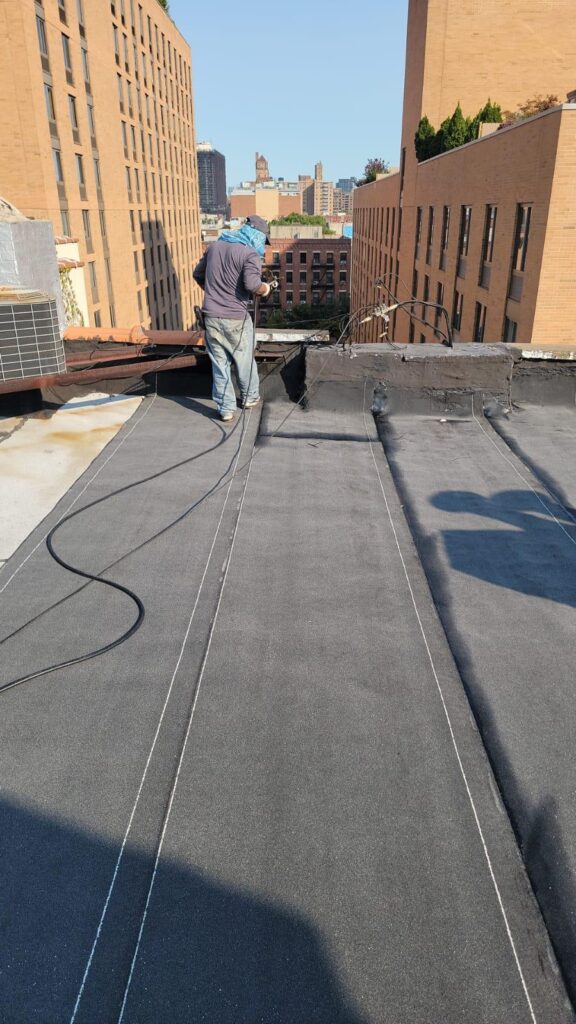 Roofer inspecting and cleaning clogged gutters on a roof