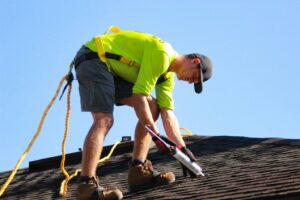mage of a construction worker on top of a roof